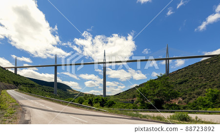 New flat straight speed Millau Viaduct above and national road D41 near Millau town. Aveyron 88723892