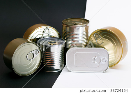 A Group of Stacked Tin Cans with Blank Edges on Split Black and White Background A Group of Stacked Tin Cans with Blank Edges on Split Black and White Background 88724164