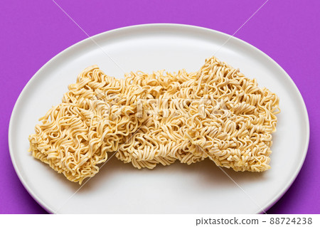 Uncooked Instant Noodles on White Plate Uncooked Instant Noodles on White Plate 88724238