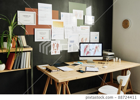 Image of modern workplace of doctor with computer monitor and certificates on wall 88724411