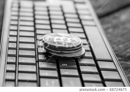 Pile of coins with Bitcoin sign over keyboard Pile of coins with Bitcoin sign over keyboard 88724675