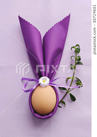 Decorative Bunny Ears with egg on purple cotton tablecloth to Celebrate Easter, DIY, flat lay Decorative Bunny Ears with egg on purple cotton tablecloth to Celebrate Easter, DIY, flat lay 88724681