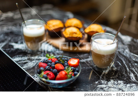 Close-up. Breakfast for two. Coffee latte with strawberry muffins. 88724896