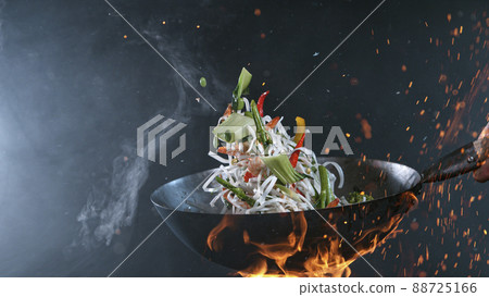 Freeze Motion of Wok Pan and Flying Ingredients in the Air. Freeze Motion of Wok Pan and Flying Ingredients in the Air. 88725166
