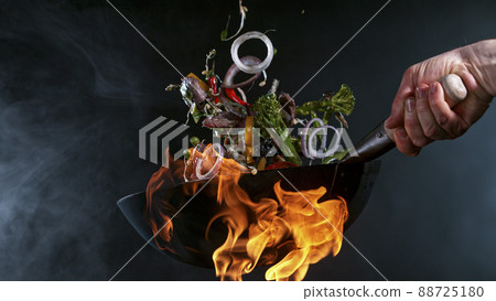 Freeze Motion of Wok Pan and Flying Ingredients in the Air. Freeze Motion of Wok Pan and Flying Ingredients in the Air. 88725180