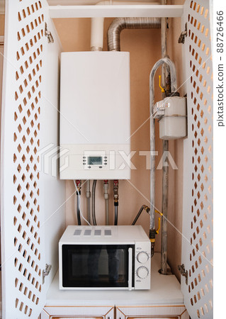 gas heating boiler and microwave in the kitchen cabinet. 88726466