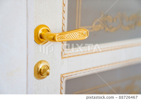 door handle. classic white interior door with gold elements. retro style. 88726467