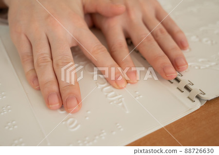 A woman learns the Braille alphabet using a decoder. A woman learns the Braille alphabet using a decoder. 88726630