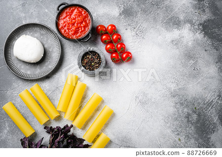 Cannelloni with spinach and ricotta, on gray stone table background, top view flat lay, with copy space for text 88726669