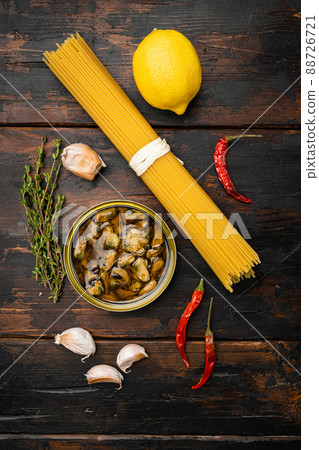 Pasta with mussels raw ingredients , on old dark wooden table background, top view flat lay Pasta with mussels raw ingredients , on old dark wooden table background, top view flat lay 88726721