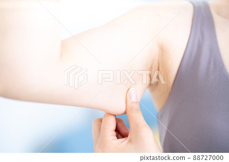A woman checking the slack in her upper arm [Parts cut] 88727000
