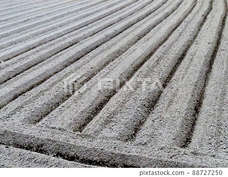 A field made of ridges with a tractor A field made of ridges with a tractor 88727250