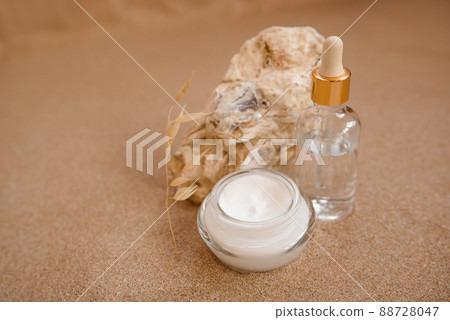 Caring cosmetics in an oyster shell on the sand. Eco-friendly organic cosmetics. Caring cosmetics in an oyster shell on the sand. Eco-friendly organic cosmetics. 88728047