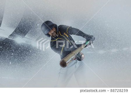One professional baseball player in sports equipment training alone isolated on a snowy background. Sport, art, action, hobby concept One professional baseball player in sports equipment training alone isolated on a snowy background. Sport, art, action, hobby concept 88728239