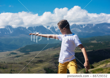 A child funny boy on the Altai mountain background. A child funny boy on the Altai mountain background. 88729332