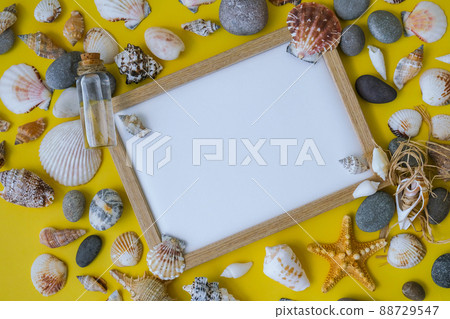 Composition frame for copy space, seashells, pebbles, mockup on yellow background. Blank, top view, still life, flat lay. sea vacation travel concept tourism and resorts. Composition frame for copy space, seashells, pebbles, mockup on yellow background. Blank, top view, still life, flat lay. sea vacation travel concept tourism and resorts. 88729547