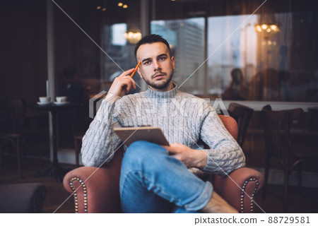 Focused man working on project with clipboard Focused man working on project with clipboard 88729581