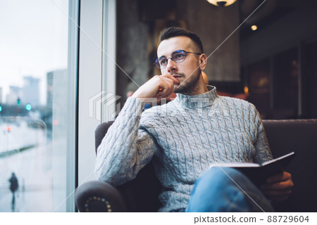 Focused man enjoying reading book 88729604