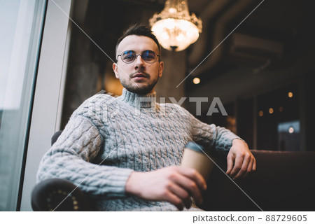 Serious man with cup of coffee 88729605