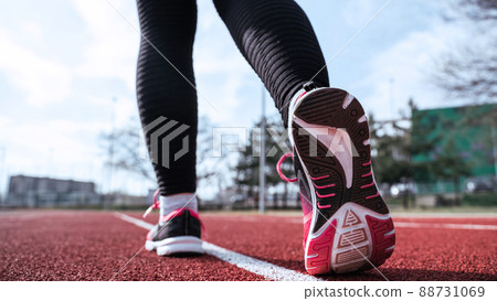 Sport run female training. Run girl workout exercise. Runner feet running on road closeup on shoe. Fitness, sport, lifestyle concept. 88731069