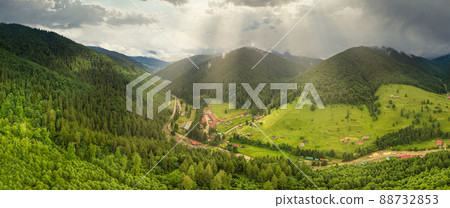 Wide-angle panoramic shot of beautiful meadows, hills and trees in Synevyrska glade next to Synevyr lake. Majestic and wonderful landscapes of the Carpathian mountains in Ukraine 88732853