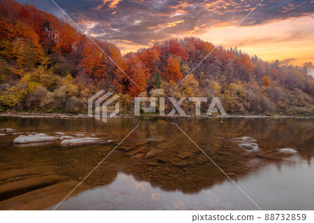 View of the waterfall in autumn. Waterfall in autumn colors. Mountain river in the autumn landscape. Ukraine, river Stryj. 88732859