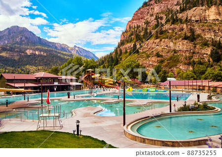 Peaceful hot springs in small town surrounded by large mountains 88735255