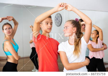 Teens in pairs learning to dance waltz 88735759