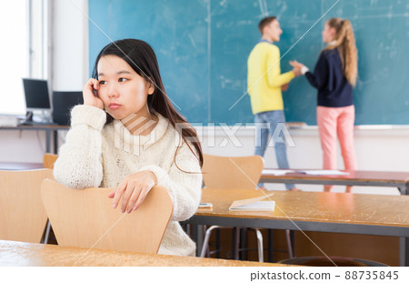 Upset Chinese girl in auditorium 88735845