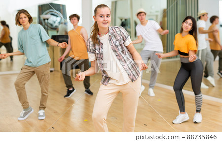 Teens performing swing dance in ballroom Teens performing swing dance in ballroom 88735846