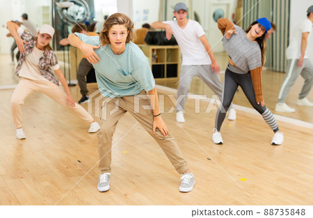 Group of teenagers rehearsing contemporary dance indoors Group of teenagers rehearsing contemporary dance indoors 88735848