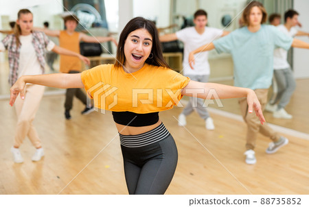 Teens performing modern dance in studio Teens performing modern dance in studio 88735852