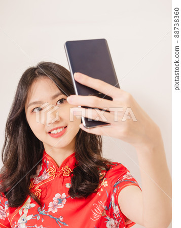 Smiling young asian woman in traditional cheongsam 88738360