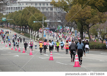 Female runner running hard at a marathon event Female runner running hard at a marathon event 88738604
