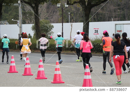 Female runner running hard at a marathon event Female runner running hard at a marathon event 88738607