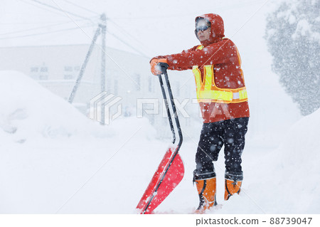 A man who is working on snow gathering in winter Snow scoop 88739047
