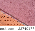 Pink wall and terra cotta roof tiles as color abstract 88740177