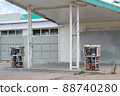 Rusted and stripped gasoline pumps at closed abandoned gasoline station 88740280