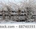 Winter wine covered pedestrian bridge walkway with fence in snow storm 88740393