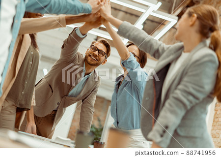 Business people giving five to their colleague in the office Business people giving five to their colleague in the office 88741956