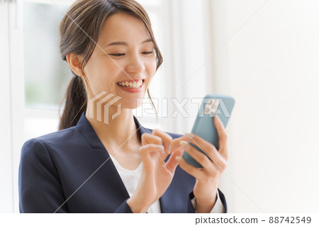 Women's suit with a smartphone Women's suit with a smartphone 88742549