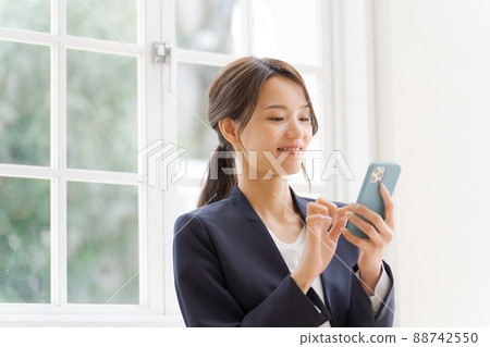 Women's suit with a smartphone 88742550