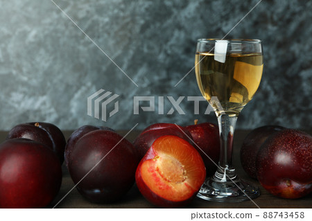 Plum vodka shot and ingredients on wooden table 88743458
