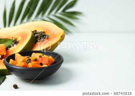 Fresh ripe papaya on white table, space for text Fresh ripe papaya on white table, space for text 88743816