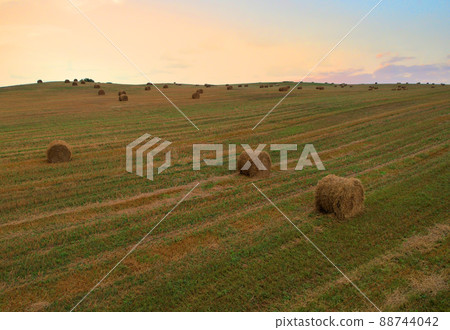 Haystack on field on sunset background. Haystack on field on sunset background. 88744042