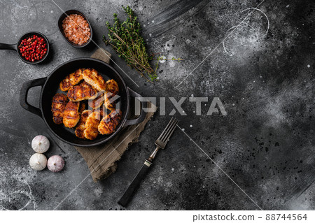 Chicken breast nuggets set, on black dark stone table background, top view flat lay, with copy space for text 88744564