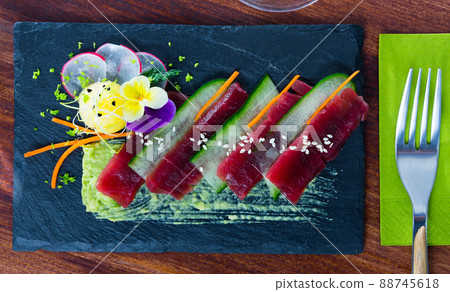 Top view of raw tuna slices with cucumber and avocado sauce Top view of raw tuna slices with cucumber and avocado sauce 88745618
