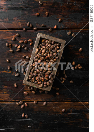 Pine wild organic nut, on old dark wooden table background, top view flat lay 88746003