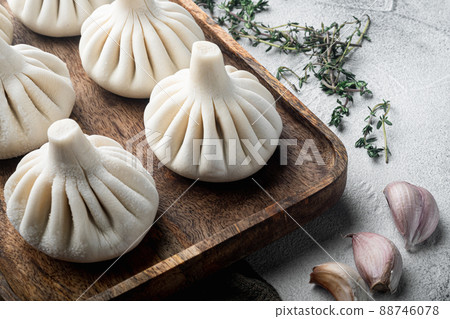 Frozen Raw dumplings Khinkali with beef and lamb meat, on gray stone background, with copy space for text 88746078