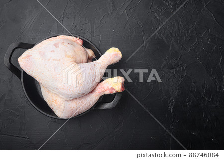 Fresh Chicken drumstick, in frying cast iron pan, on black stone background, top view flat lay, with copy space for text Fresh Chicken drumstick, in frying cast iron pan, on black stone background, top view flat lay, with copy space for text 88746084